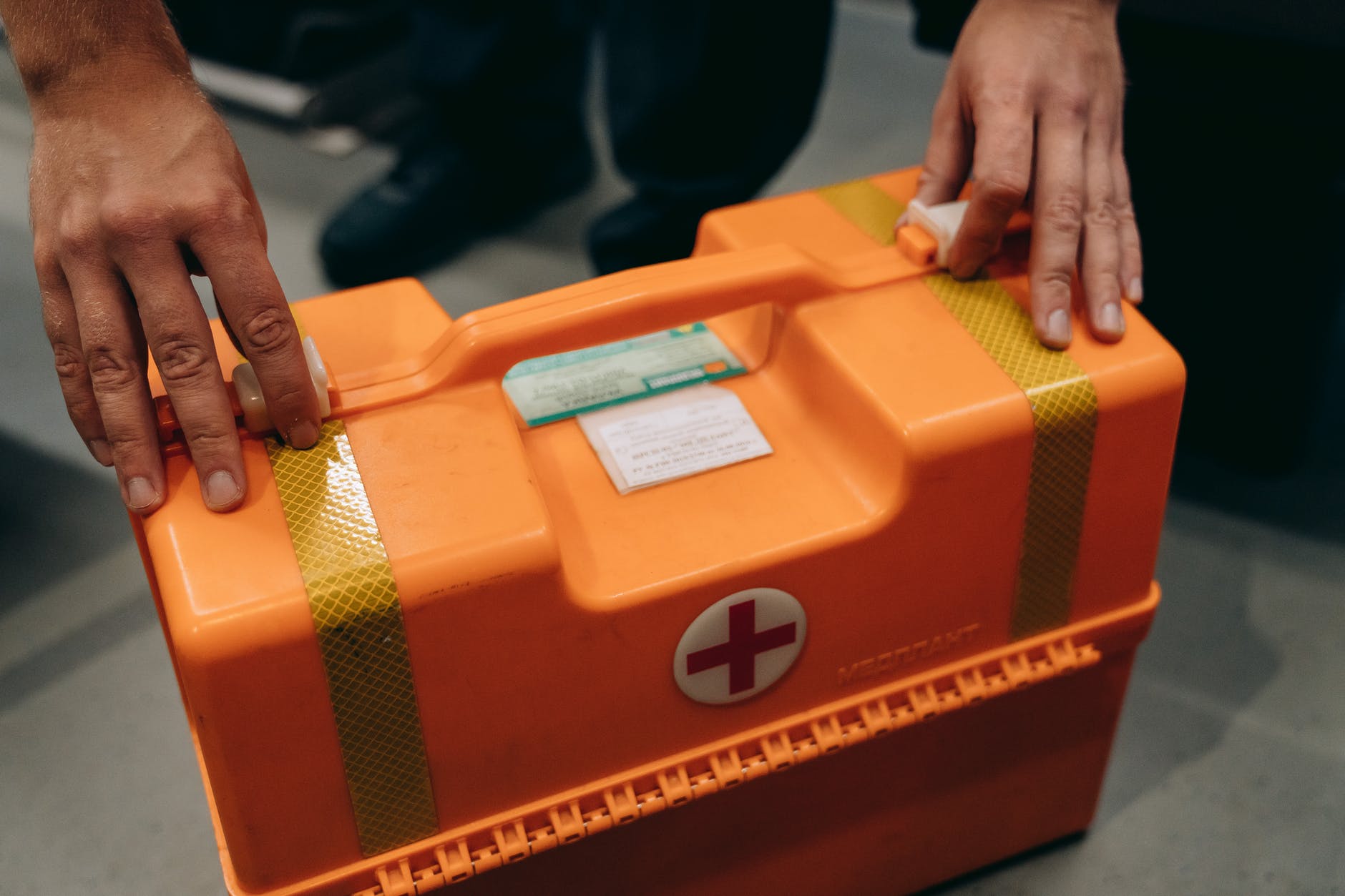 a person holding a first aid kit